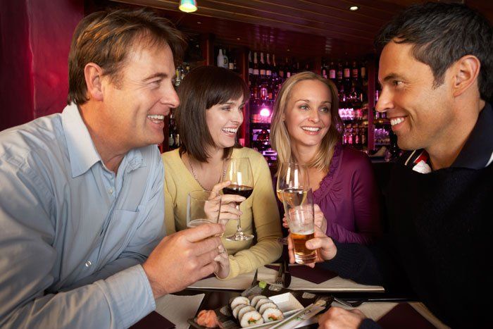 Group of friends enjoying sushi in a Restaurant